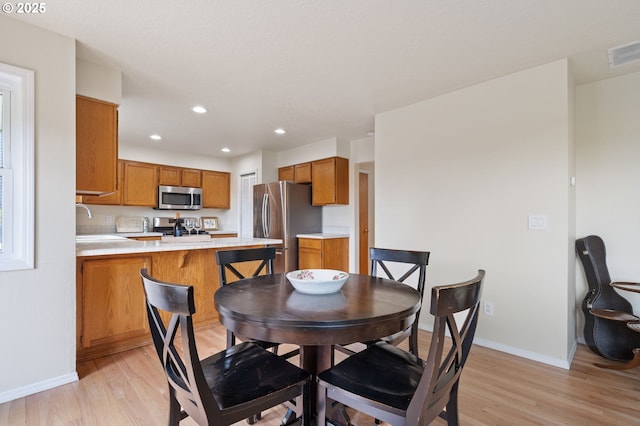 11442 SW Woodlee Heights Ct, Portland, OR 97219 - dining area featuring light wood-type flooring and recessed lighting