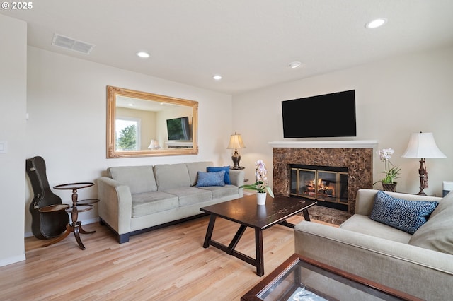 11442 SW Woodlee Heights Ct, Portland, OR 97219 - living room featuring light wood-style flooring, recessed lighting, and a high end fireplace