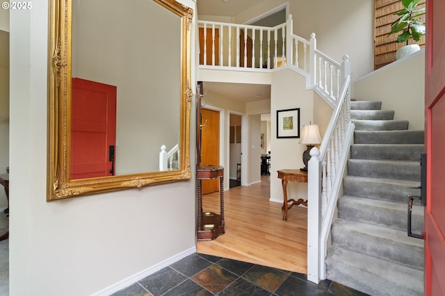 11442 SW Woodlee Heights Ct, Portland, OR 97219 - foyer featuring stairway, stone tile floors, and a high ceiling