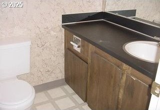 3701 SW Condor Ave Unit C2, Portland, OR 97239 - detailed view of vanity, a textured wall, and tile patterned floors