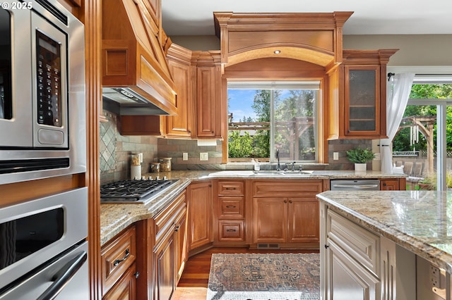 7102 SW 78th Ave, Portland, OR 97223 - kitchen with a sink, stainless steel appliances, light stone countertops, and decorative backsplash