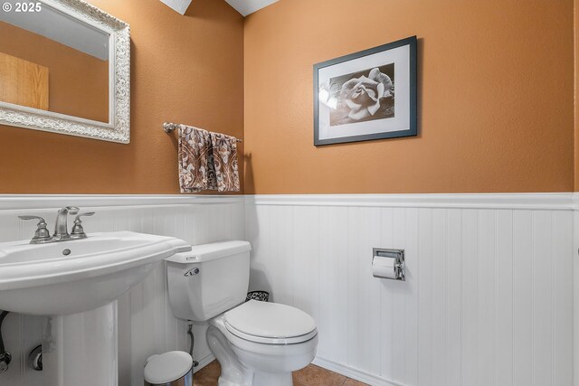 3003 NE 164th St, Ridgefield, WA 98642 - bathroom featuring a wainscoted wall, toilet, and a sink