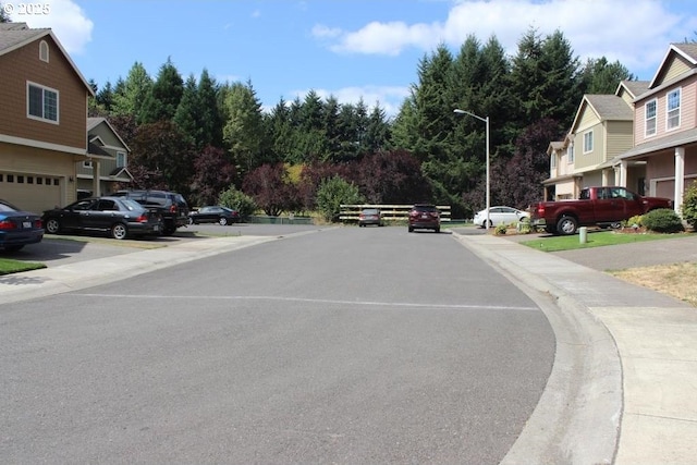 5906 NE 56th St, Vancouver, WA 98661 - view of asphalt street featuring street lights, sidewalks, and curbs