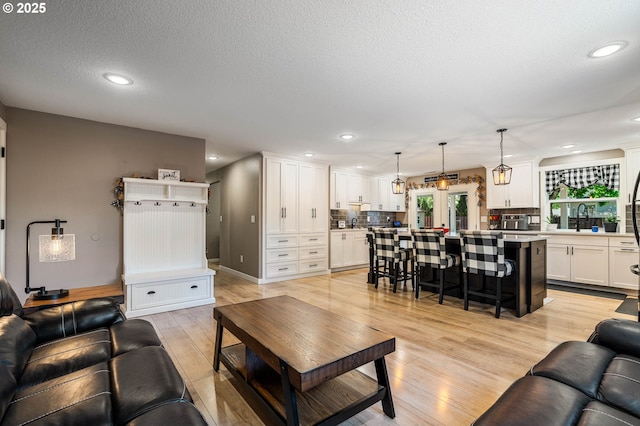 3817 NW Mccann Rd, Vancouver, WA 98685 - living area featuring light wood finished floors, recessed lighting, and a textured ceiling