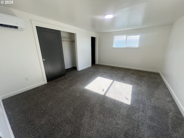 1801 Jackson Ave, La Grande, OR 97850 - unfurnished bedroom with a wall mounted air conditioner, dark carpet, baseboards, and a closet