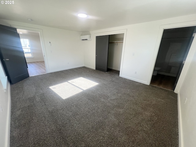 1801 Jackson Ave, La Grande, OR 97850 - unfurnished bedroom with carpet floors, a wall mounted AC, baseboards, a closet, and ensuite bathroom