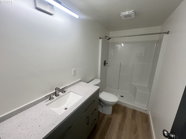 1801 Jackson Ave, La Grande, OR 97850 - bathroom with vanity, wood finished floors, toilet, and a shower