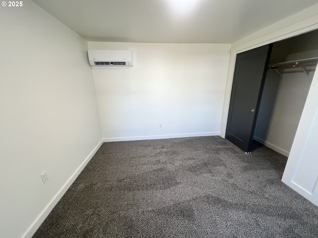1801 Jackson Ave, La Grande, OR 97850 - unfurnished bedroom with a wall unit AC, dark carpet, baseboards, and a closet