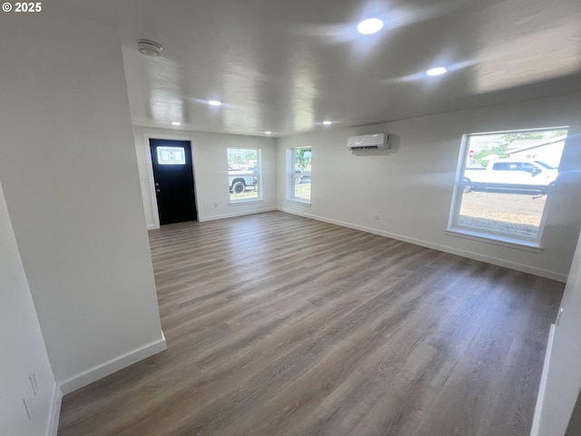 1801 Jackson Ave, La Grande, OR 97850 - spare room with a wall unit AC, baseboards, wood finished floors, recessed lighting, and a smoke detector