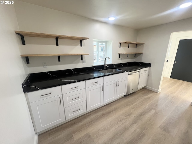 1801 Jackson Ave, La Grande, OR 97850 - kitchen with open shelves, a sink, dishwasher, light wood-style flooring, and white cabinets