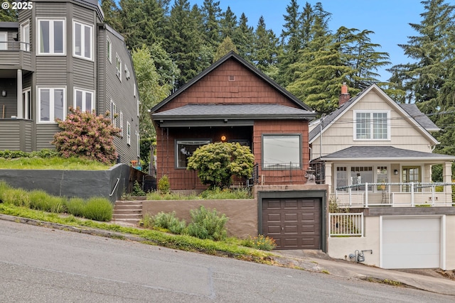 view of front of property with a garage and roof with shingles