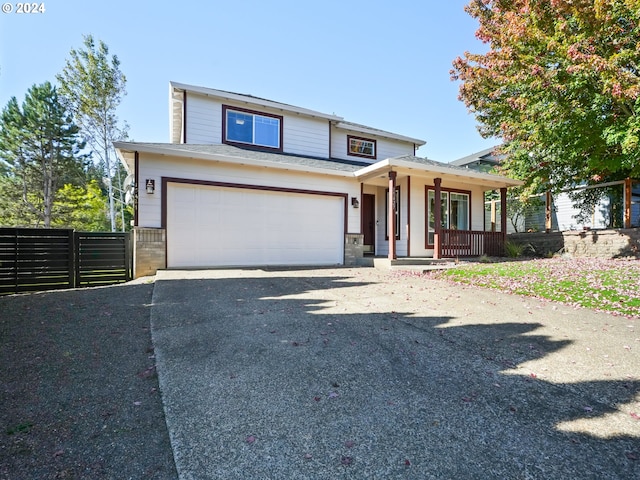 view of front of house featuring a porch and a garage