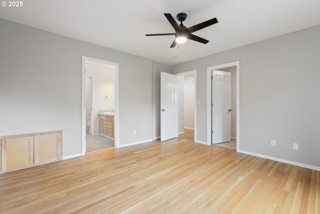 unfurnished bedroom with light wood-type flooring, connected bathroom, ceiling fan, and sink