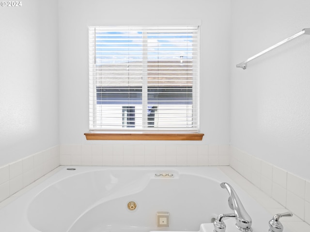 bathroom with a relaxing tiled tub