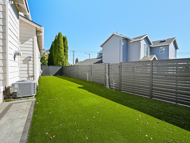 view of yard featuring central air condition unit