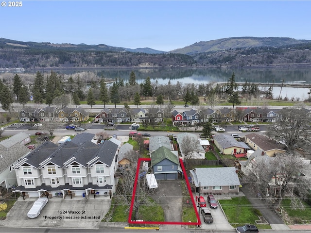 birds eye view of property with a residential view and a water and mountain view