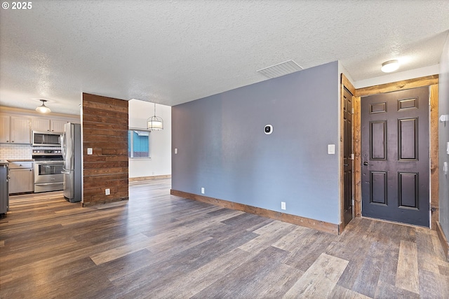 20694 SW Parker Ct, Beaverton, OR 97078 - kitchen with stainless steel appliances, dark wood finished floors, a textured ceiling, decorative backsplash, and light countertops