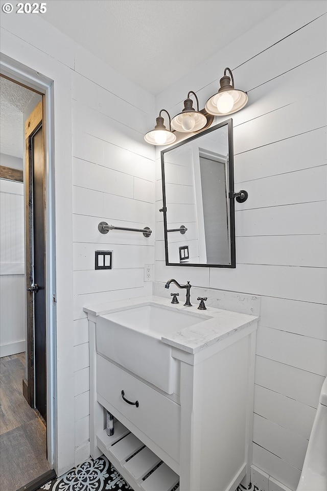 20694 SW Parker Ct, Beaverton, OR 97078 - bathroom featuring vanity, wood walls, and a textured ceiling
