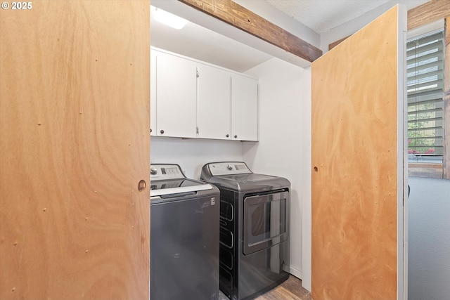 20694 SW Parker Ct, Beaverton, OR 97078 - laundry area featuring cabinet space, washing machine and clothes dryer, and wood finished floors