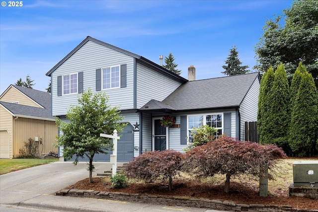 20694 SW Parker Ct, Beaverton, OR 97078 - view of front of home with a garage, driveway, a chimney, and a shingled roof