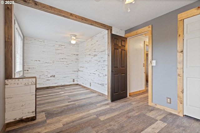20694 SW Parker Ct, Beaverton, OR 97078 - unfurnished room with a ceiling fan, wood finished floors, and wood walls