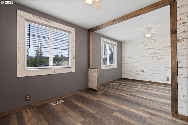 20694 SW Parker Ct, Beaverton, OR 97078 - unfurnished room with a ceiling fan, wooden walls, wood finished floors, and an accent wall
