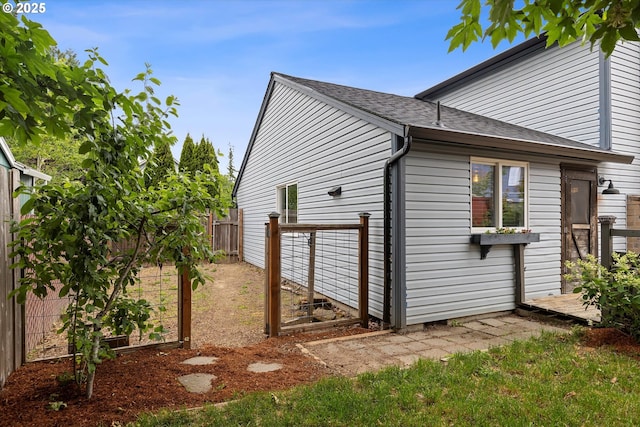 20694 SW Parker Ct, Beaverton, OR 97078 - view of side of home with a fenced backyard and a shingled roof