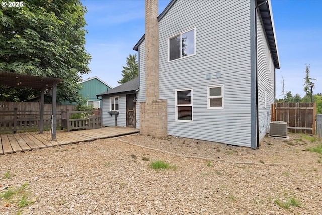 20694 SW Parker Ct, Beaverton, OR 97078 - back of house with a deck, a fenced backyard, a chimney, and a pergola