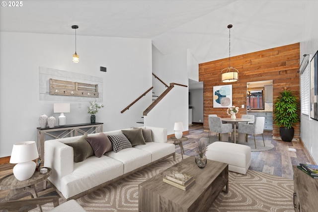 20694 SW Parker Ct, Beaverton, OR 97078 - living room featuring wood finished floors, high vaulted ceiling, wooden walls, and stairs