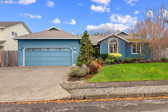 view of front of house featuring a front yard and a garage