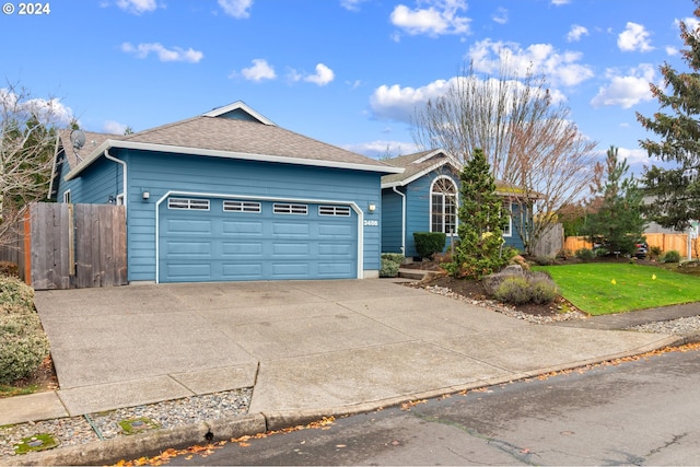 single story home with a front yard and a garage