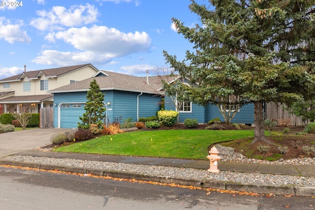 view of front of home with a garage and a front yard