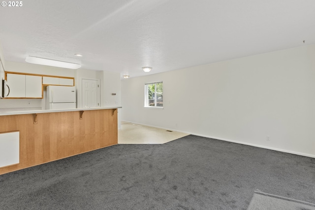 3617 Westleigh St, Eugene, OR 97405 - unfurnished living room featuring light carpet and baseboards