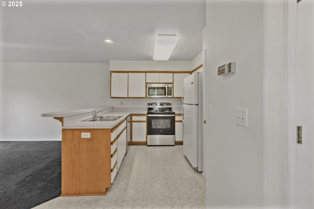 3617 Westleigh St, Eugene, OR 97405 - kitchen with stainless steel appliances, a peninsula, light countertops, and recessed lighting