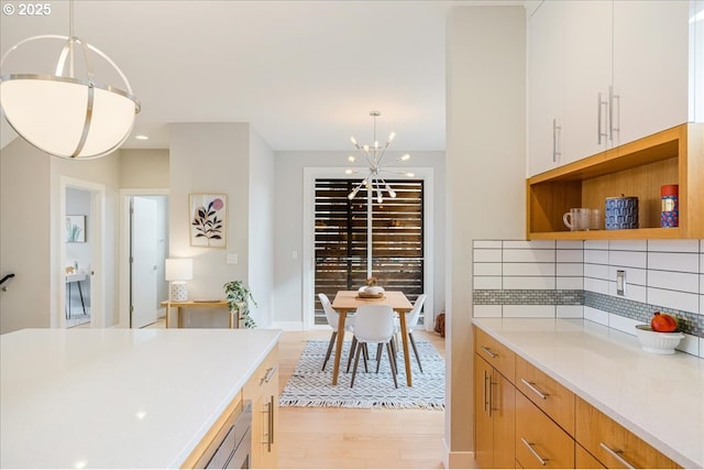 interior space with recessed lighting, a notable chandelier, and light wood finished floors