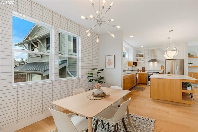 dining space featuring recessed lighting, a chandelier, and light wood-type flooring