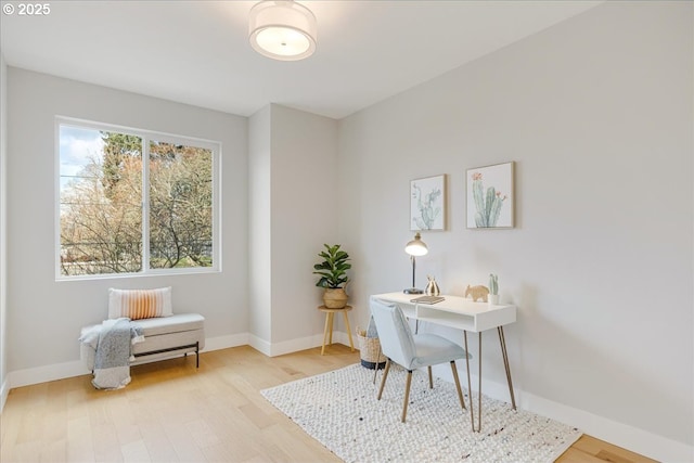 office featuring baseboards and light wood-style flooring