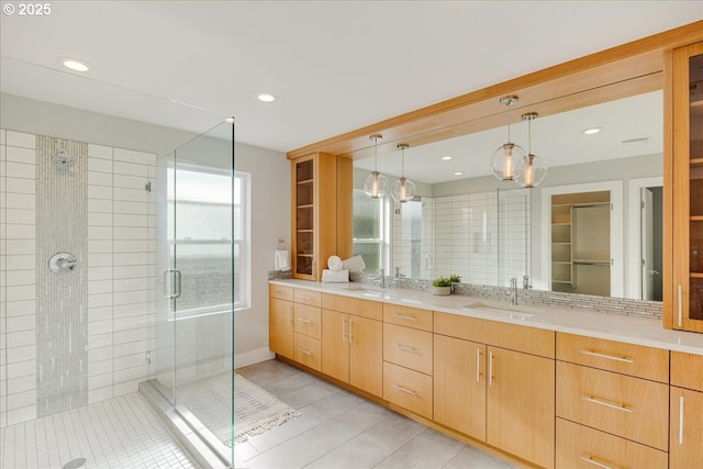 bathroom with double vanity, recessed lighting, tile patterned floors, a sink, and a stall shower