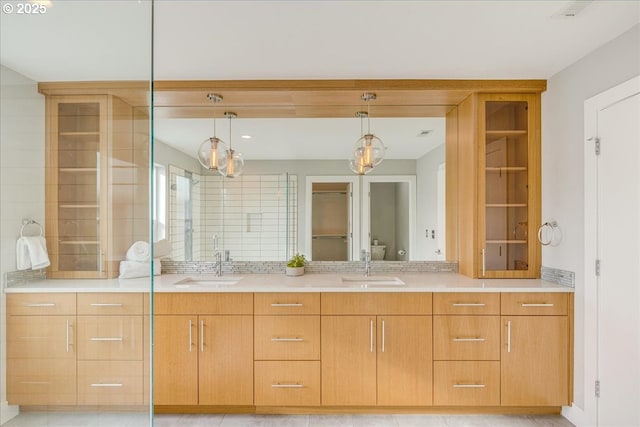 bathroom featuring a sink, toilet, and double vanity