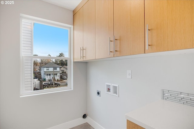 washroom with cabinet space, hookup for an electric dryer, baseboards, and hookup for a washing machine