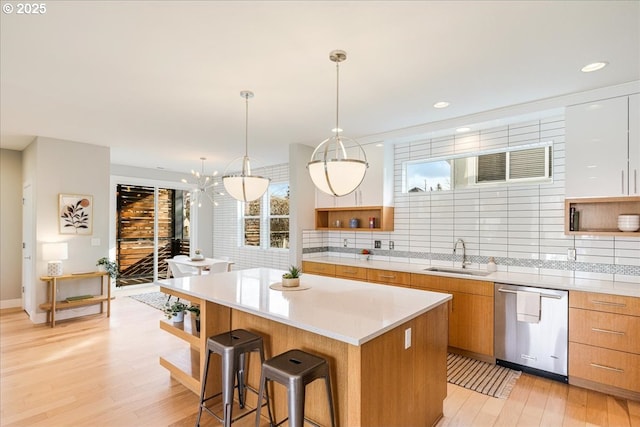 kitchen featuring a kitchen island, modern cabinets, open shelves, dishwasher, and a sink