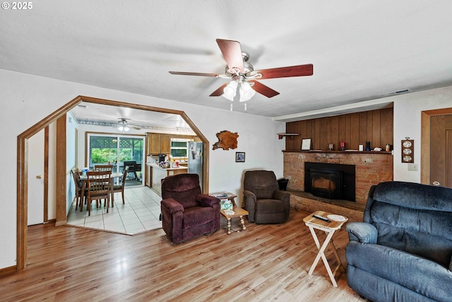 808 E 14th St, Coquille, OR 97423 - living room featuring a ceiling fan, light wood finished floors, and a fireplace