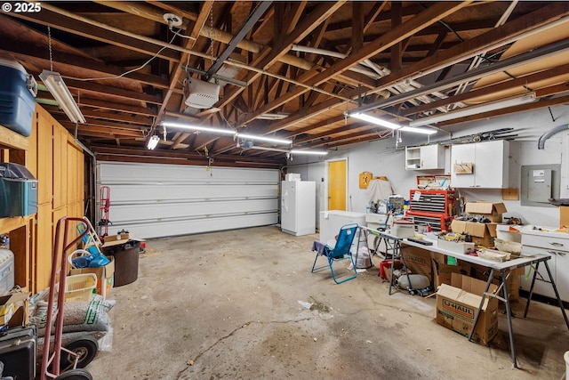 808 E 14th St, Coquille, OR 97423 - garage with white refrigerator with ice dispenser, a garage door opener, and a workshop area