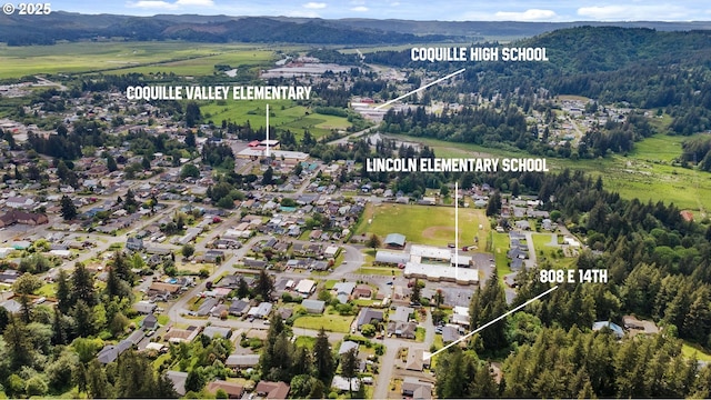 808 E 14th St, Coquille, OR 97423 - aerial view of property's location with a mountain backdrop and property parcel outlined