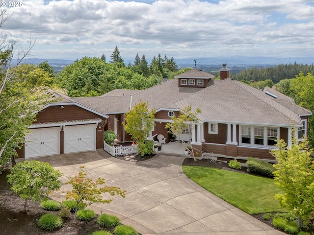 9320 NW Skyview Ct, Portland, OR 97231 - view of front facade with a chimney, driveway, a garage, roof with shingles, and covered porch