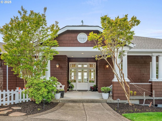 9320 NW Skyview Ct, Portland, OR 97231 - view of exterior entry with covered porch and a shingled roof