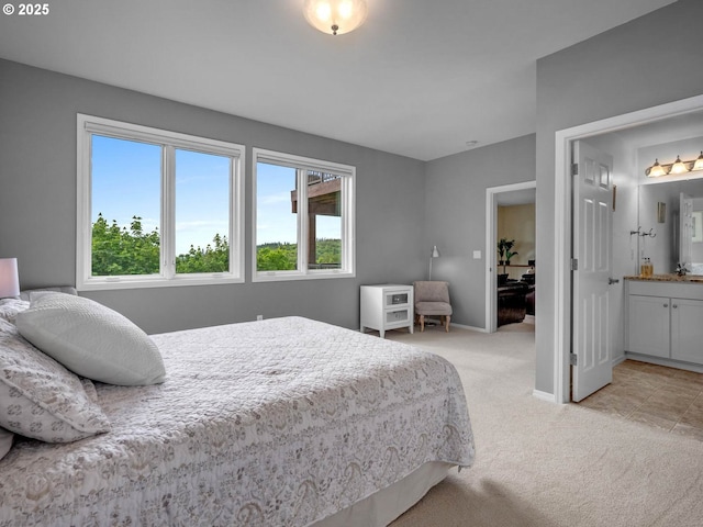 9320 NW Skyview Ct, Portland, OR 97231 - bedroom with light carpet, multiple windows, baseboards, and connected bathroom