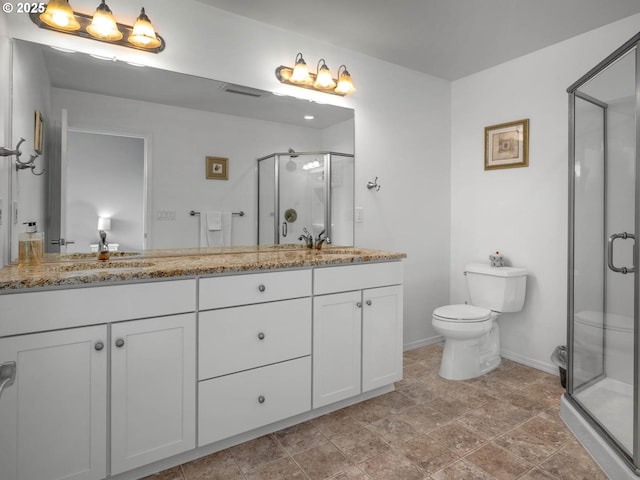 9320 NW Skyview Ct, Portland, OR 97231 - full bathroom featuring toilet, a shower stall, baseboards, double vanity, and stone finish floors