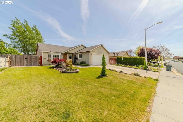 ranch-style home with an attached garage, fence, driveway, and a front yard