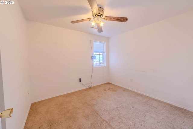 empty room with a ceiling fan, baseboards, and light carpet